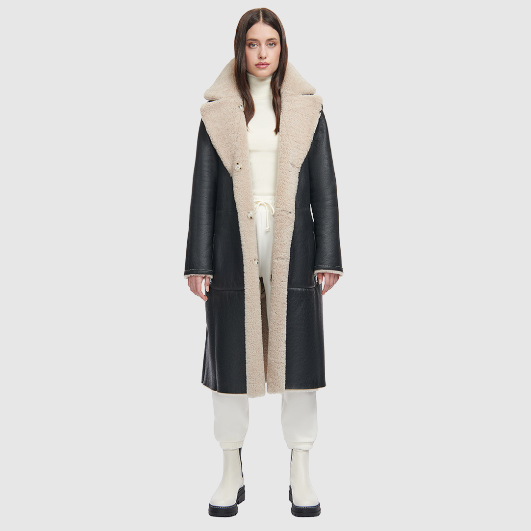 This product features Nappa curly wool shearling with a vintage-inspired, reversible notch collar. On one side, you'll find a soft teddy bear-like texture, while the other boasts a smooth nappa finish. The relaxed, dropped shoulder adds to the overall comfort, and the 3-button closure allows for a secure fit. A tie belt is included for added style on the reversed side, and there are zip pockets on the nappa side, with patch pockets on the teddy side.