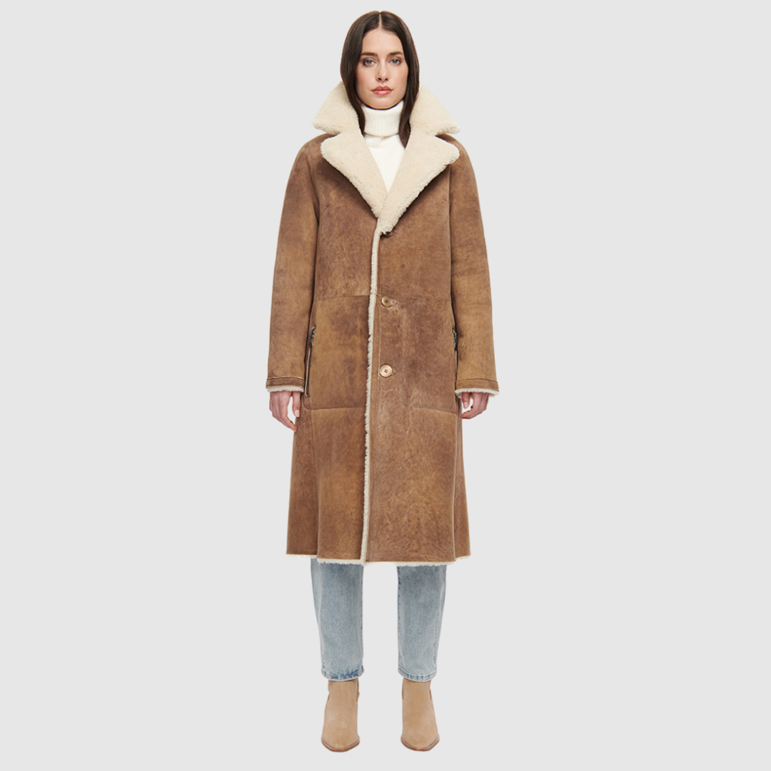 Suede curly wool shearling Vintage inspired reversible notch collar Reverses to curly wool teddy Relaxed dropped shoulder 3 button closure Tie belt at waist Zip pockets on suede side, reverses to patch pockets on teddy side