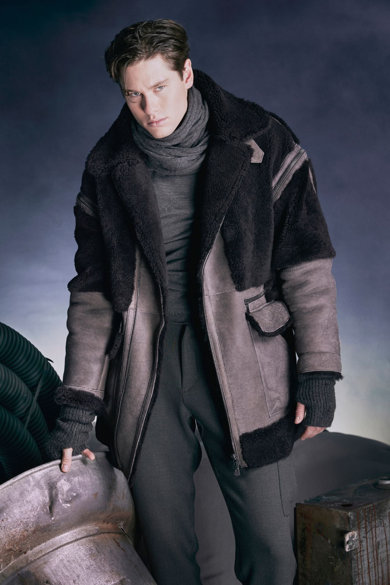 Discover Guardian, our designer mens shearling. A 34" wool jacket featuring wool panels. Convertible to a vest with zip-off sleeves, it offers versatility. This zip-front black Spanish sheepskin coat provides optimal winter defense with an oversized notched collar, collar tabs with belt-loop closure, two-way zipper, and interior zipper pocket, blending fashion with functionality.