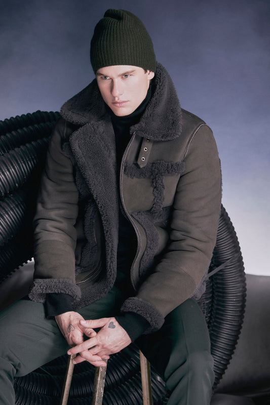 Discover Umberto, our designer mens shearling moto jacket with contrast curly wool out detail. True to size and featuring a standard zip closure, it exudes urban sophistication. With a spread collar adorned with a moto buckle and an interior zip pocket, this jacket combines style and functionality for the perfect winter statement.