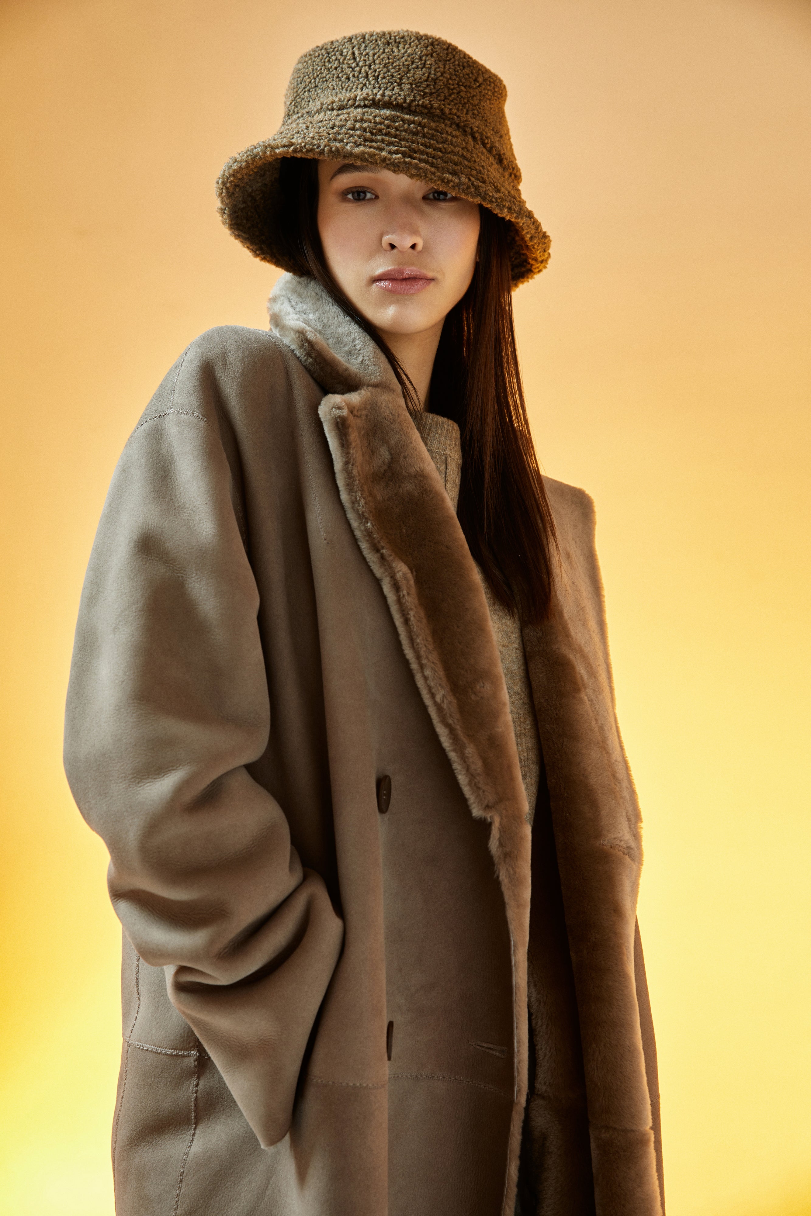 Danielle: This elegant, reversible full-length shearling coat offers two beautiful styles in one. 51" long. It reverses from a beautiful nappa finish to a plush fur-out style and has two slip pockets. Made from genuine Spanish merino shearling sheepskin. Double breasted. Slight dropped shoulder fits comfortably across the shoulders. Loose fit through the torso.
