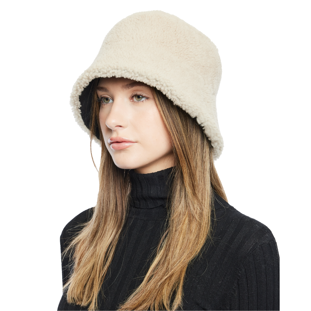 Elevate your winter look with our reversible shearling bucket hat, featuring black nappa leather on one side and beige curly wool on the other. This designer accessory offers versatility, warmth, and style. Stay cozy and chic all season long with this premium addition to your cold-weather wardrobe.