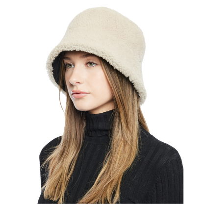 Elevate your winter look with our reversible shearling bucket hat, featuring black nappa leather on one side and beige curly wool on the other. This designer accessory offers versatility, warmth, and style. Stay cozy and chic all season long with this premium addition to your cold-weather wardrobe.