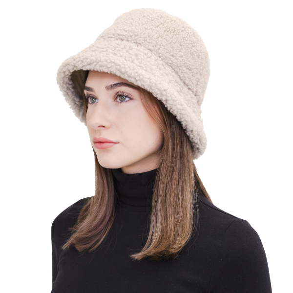 Elevate your winter style with our reversible shearling curly wool bucket hat in cement/beige, also reversible to nylon with topstitching. This designer accessory offers warmth, versatility, and premium craftsmanship. Stay cozy and chic all season long with this must-have addition to your cold-weather wardrobe.