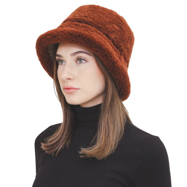 Elevate your winter style with our reversible chocolate/beige shearling curly wool bucket hat, featuring a versatile design that flips to nylon with topstitching. Crafted with premium materials, this designer accessory offers warmth, comfort, and sophistication. Stay cozy and chic all season long with this essential addition to your cold-weather wardrobe.