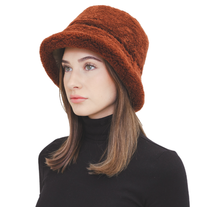 Elevate your winter style with our reversible chocolate/beige shearling curly wool bucket hat, featuring a versatile design that flips to nylon with topstitching. Crafted with premium materials, this designer accessory offers warmth, comfort, and sophistication. Stay cozy and chic all season long with this essential addition to your cold-weather wardrobe.