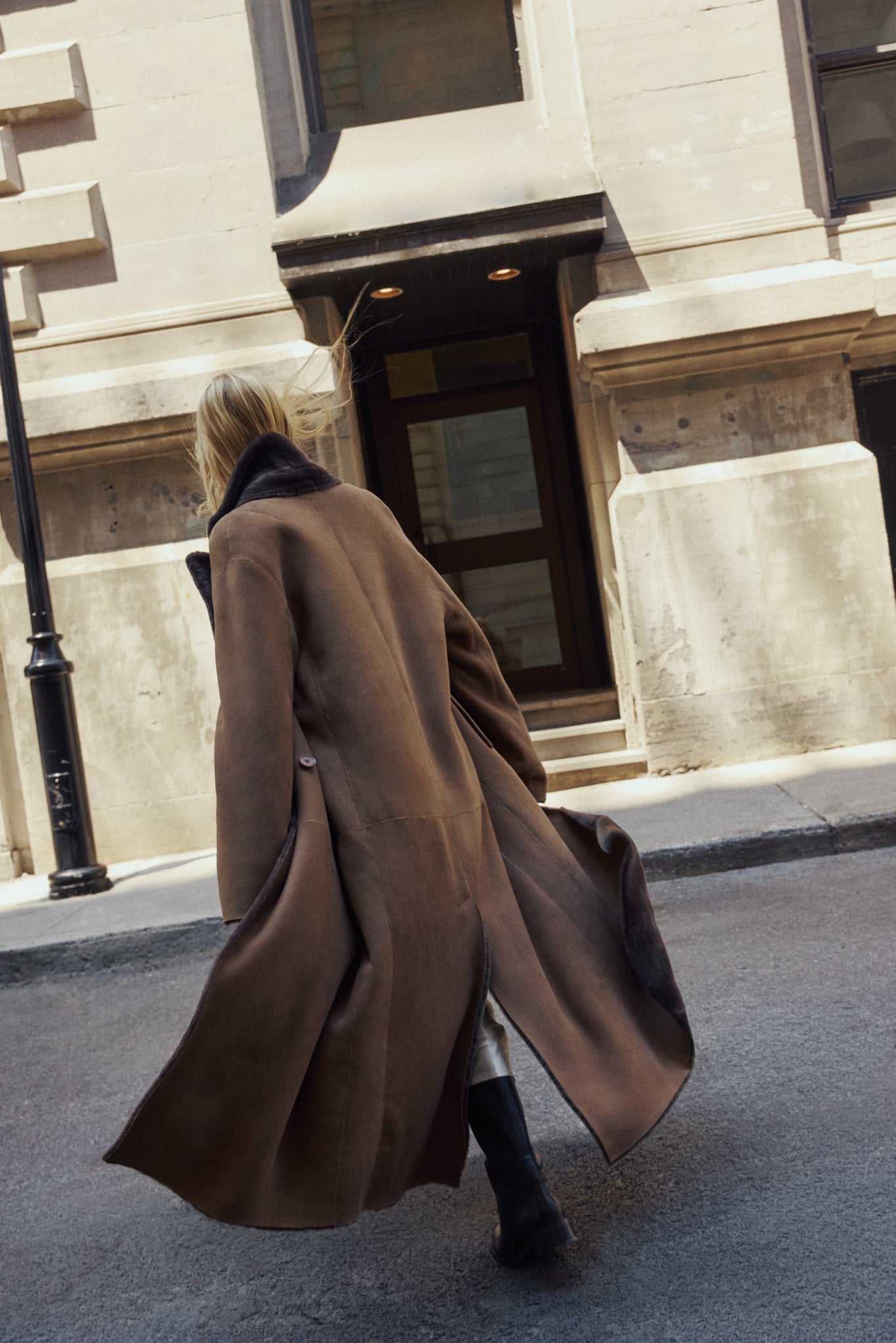 The DANIELLE Duster is a statement in heritage-inspired luxury and modern versatility. Crafted in kangaroo suede leather and plush curly wool shearling, this reversible oversized coat transitions effortlessly from sleek leather to cozy teddy texture. Its elongated silhouette is enhanced with a slight drop shoulder, back vent, and double-breasted button closure, creating timeless elegance with functional edge. Practical single welt pockets on the suede side and slash pockets on the wool side.