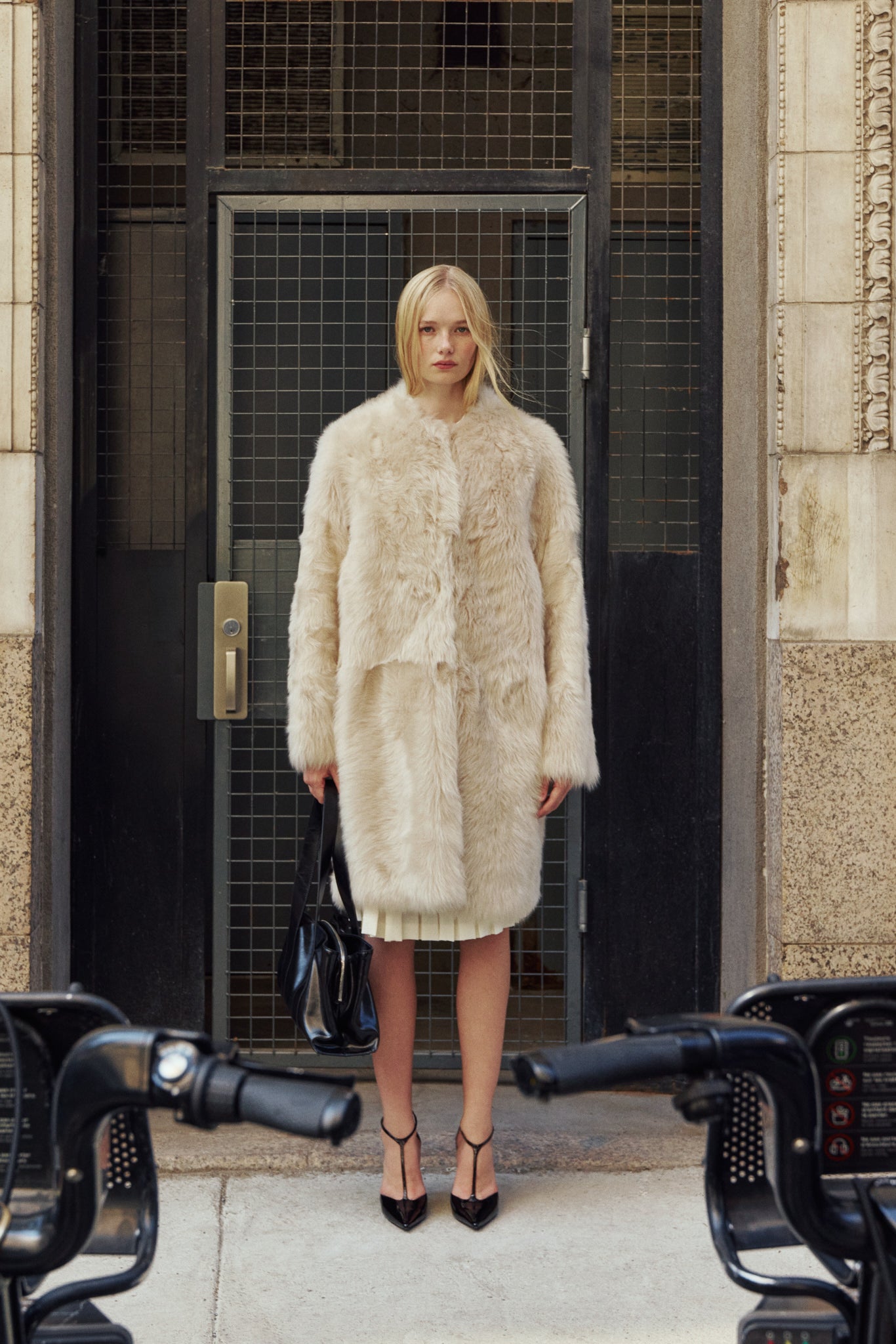 The ALLORA Jacket is a luxury reversible shearling teddy crafted in parchment toscana for a rich and modern finish. Designed as a collarless regular fit silhouette, it effortlessly flips from plush wool-out shearling to a sleek nappa skin-out jacket, offering two looks in one. With its generous fit through the shoulders, arms, and torso, ALLORA balances comfort and style. Functional slash side pockets on both sides and a front snap closure complete this elevated women’s reversible shearling jacket.