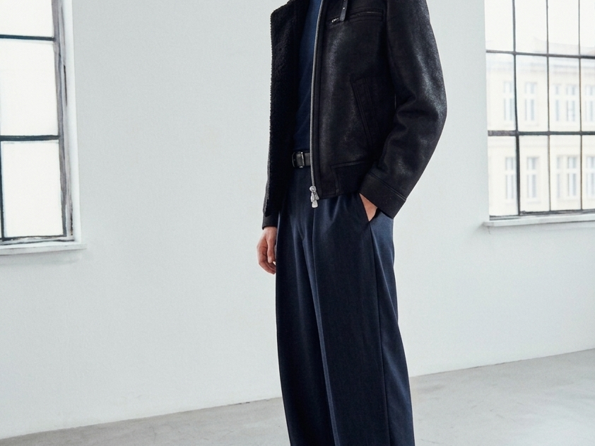 The ARIES Jacket is a heritage-inspired shearling moto crafted in jet black cracked nappa leather with plush curly wool on the interior. Designed for a structured silhouette with regular shoulders and a clean hem, ARIES combines rugged edge with refined texture. Functional welt pockets, a zip chest pocket, and a front zip closure make this jacket as practical as it is versatile, perfect for cold-weather layering or elevated city styling.