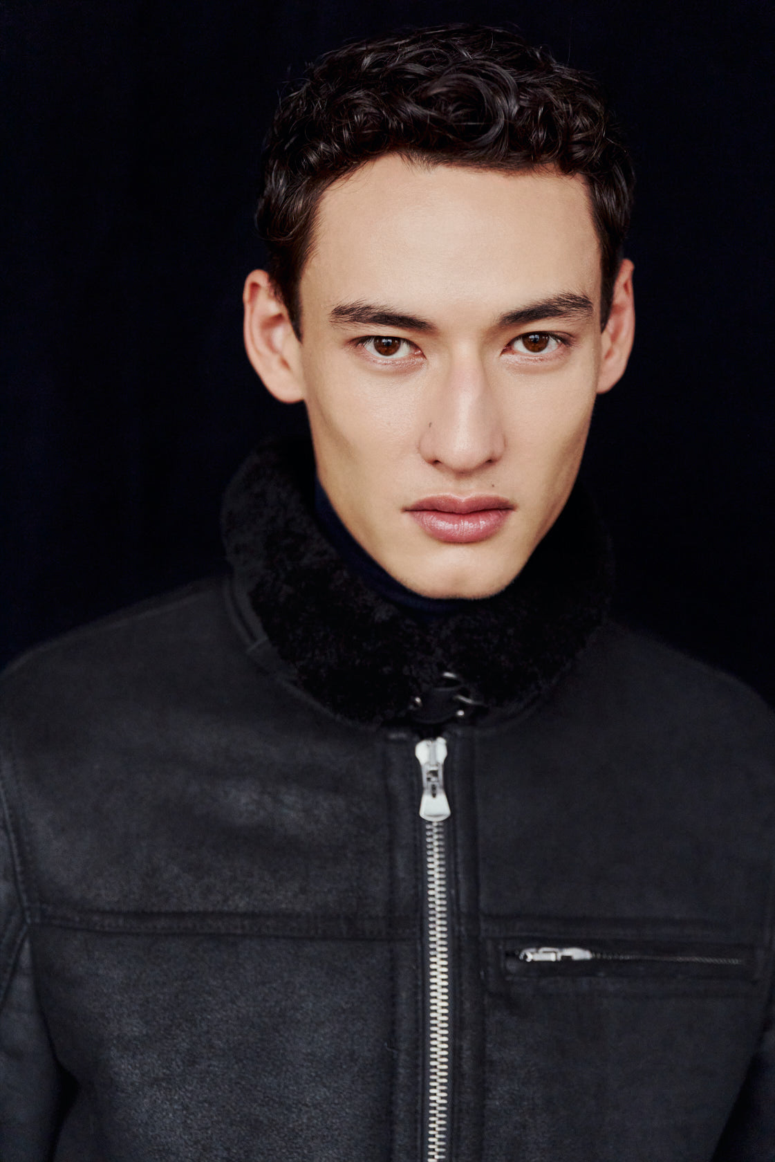 The ARIES Jacket is a heritage-inspired shearling moto crafted in jet black cracked nappa leather with plush curly wool on the interior. Designed for a structured silhouette with regular shoulders and a clean hem, ARIES combines rugged edge with refined texture. Functional welt pockets, a zip chest pocket, and a front zip closure make this jacket as practical as it is versatile, perfect for cold-weather layering or elevated city styling.