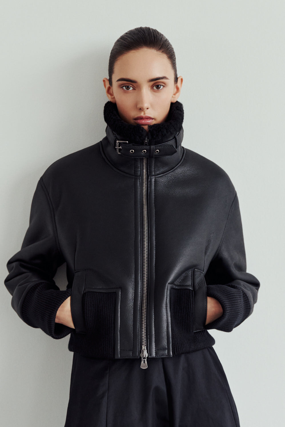 The CAVALLO delivers sharp alpine chic tailored for a metropolitan winter. This bomber jacket pairs rich nappa leather with a plush cream iron wool interior. Featuring integrated ribbed knit trim and a bold buckled collar, the cropped silhouette balances high-fashion utility with quiet luxury. Ideal for effortless layering, it moves easily from casual streetwear to an upscale cold-weather destination.