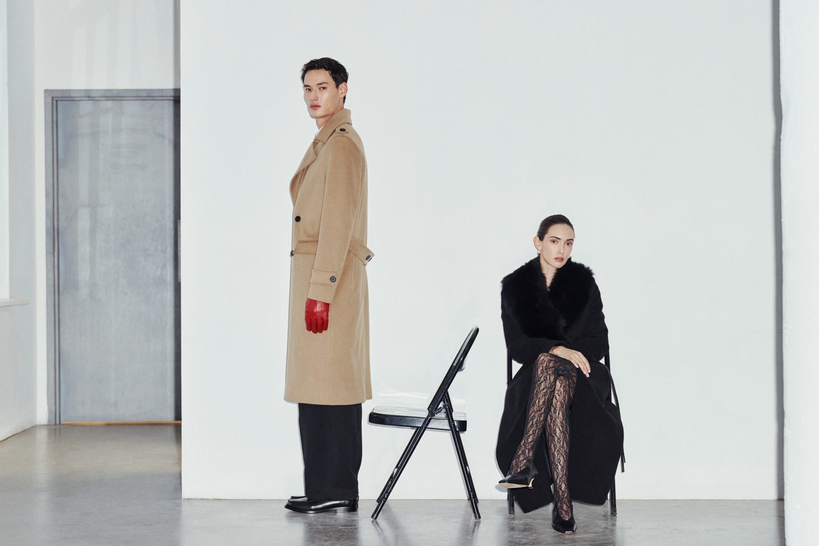 Tailored for timeless cold-weather style, the men's JOSEPH and women's ESTELLE coats combine classic structure with rich, luxurious materials. Crafted in rich camel wool,  JOSEPH brings a sharp, military-inspired edge with its longline double-breasted silhouette, structured shoulders, wide peaked lapels, shoulder epaulets, and functional flap pocketing. Complementing its masculine precision, the ESTELLE offers sweeping drama in deep jet-black wool-cashmere, featuring a plush Toscana wool shawl collar