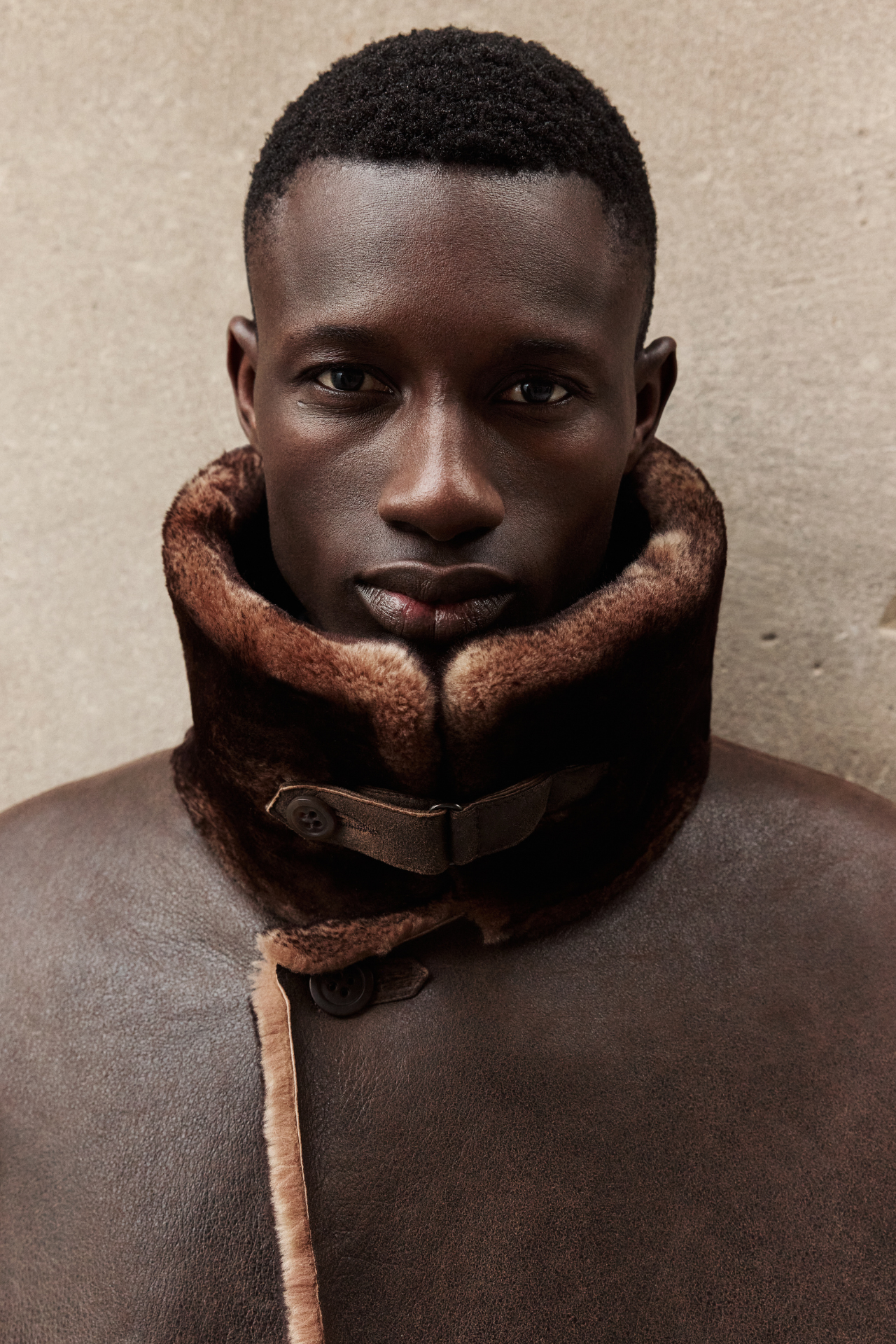 This reversible shearling coat is the ultimate in versatile luxury outerwear. Crafted from premium suede, it reverses to a cozy iron wool teddy for two distinct looks. Medium in length with a raw edge finish, it features a spread collar with tab, single welt pocket on the suede side, and slash pocket on the wool side. The fit is true to size when worn skin-out and relaxed when reversed. Finished with a single-breasted button closure for timeless appeal.