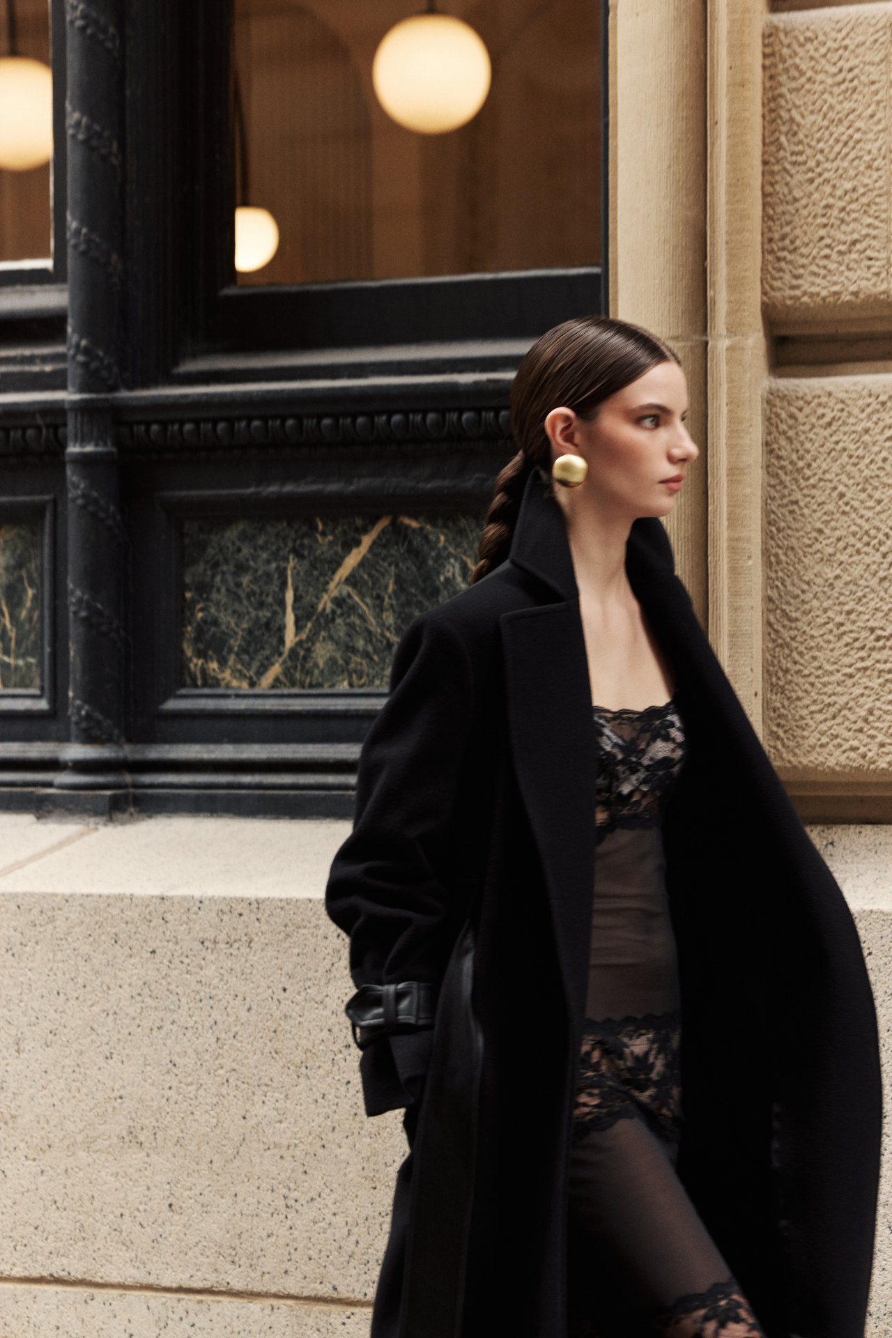 This sophisticated women's coat is a stylish wool trench coat featuring chic leather detail accents and distinctive sleeve straps. It boasts a classic notched collar. This elegant piece of outerwear offers a timeless silhouette. A perfect wool trench coat for a polished look.