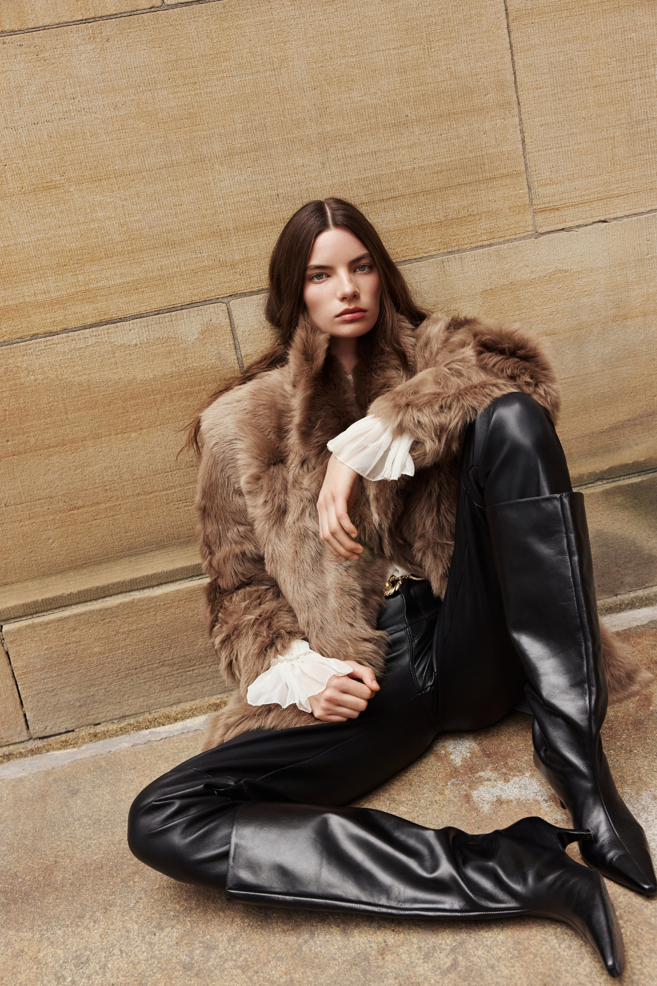 Wrap yourself in the epitome of cold-weather luxury with this statement shearling coat. Crafted from plush, long-haired shearling, this oversized outerwear piece features a dramatic notch collar and a textured, voluminous silhouette. Perfect as a winter jacket or chic layering coat, it combines warmth with modern elegance. Style it over leather pants or denim for an effortlessly bold look. A must-have shearling jacket that redefines elevated outerwear for the season.