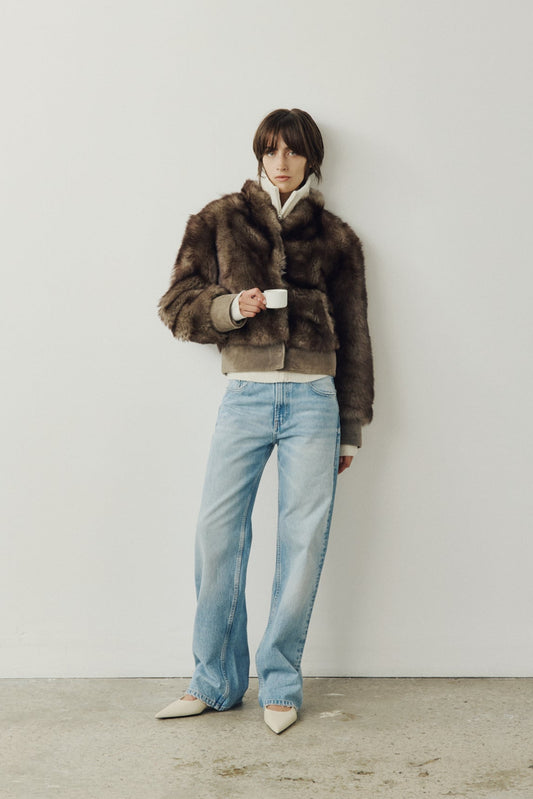 Elevate your outerwear collection with our Women's Cropped Toscana Wool Bomber. Designed for bold style and warmth, this luxe jacket features oversized shoulders and a sleek stand collar for a modern edge. Fully lined for comfort, it offers practical slash side pockets and a secure hook closure. Perfect for chilly days, this statement bomber blends fashion and function, making it an essential addition to any winter wardrobe.