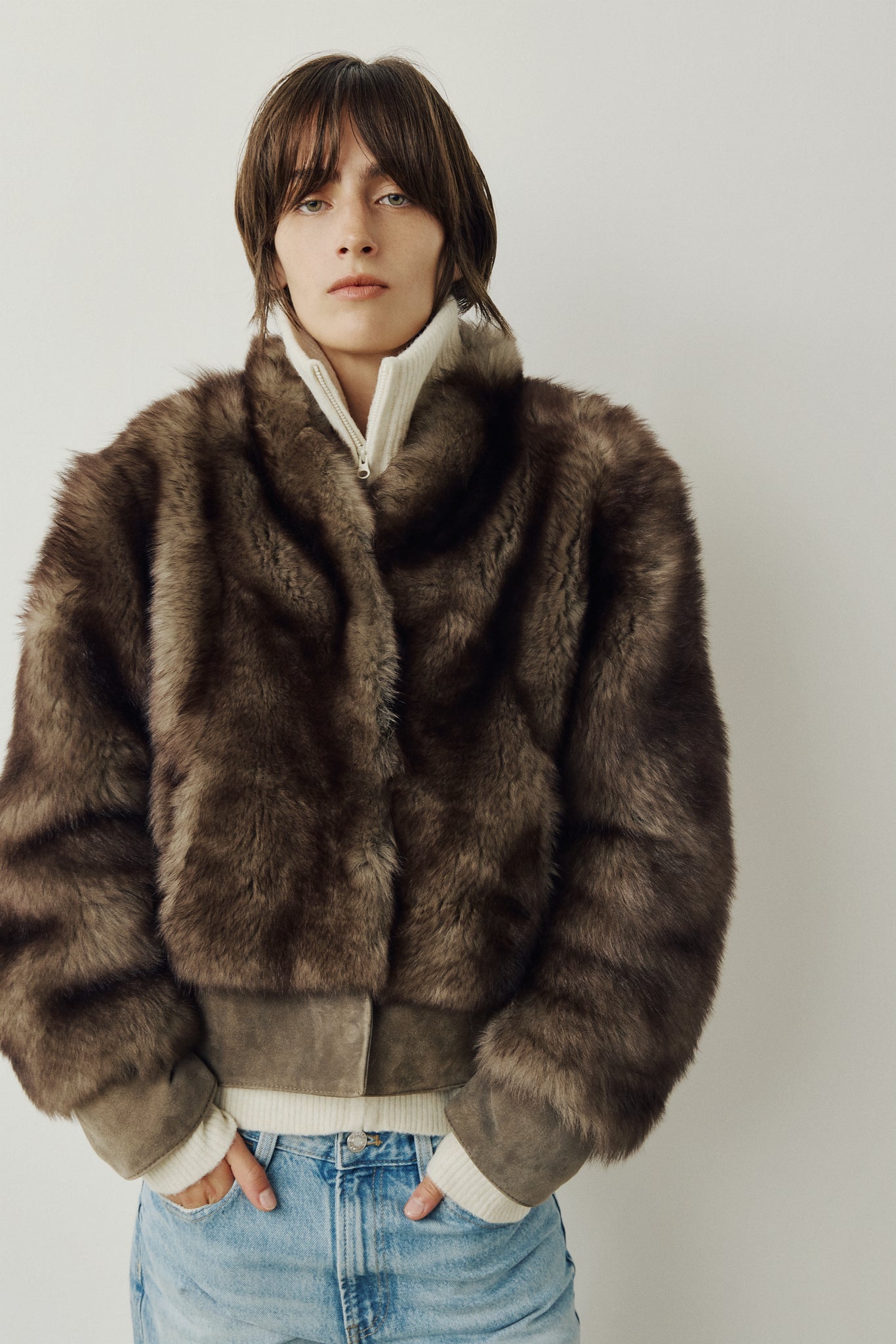 Elevate your outerwear collection with our Women's Cropped Toscana Wool Bomber. Designed for bold style and warmth, this luxe jacket features oversized shoulders and a sleek stand collar for a modern edge. Fully lined for comfort, it offers practical slash side pockets and a secure hook closure. Perfect for chilly days, this statement bomber blends fashion and function, making it an essential addition to any winter wardrobe.