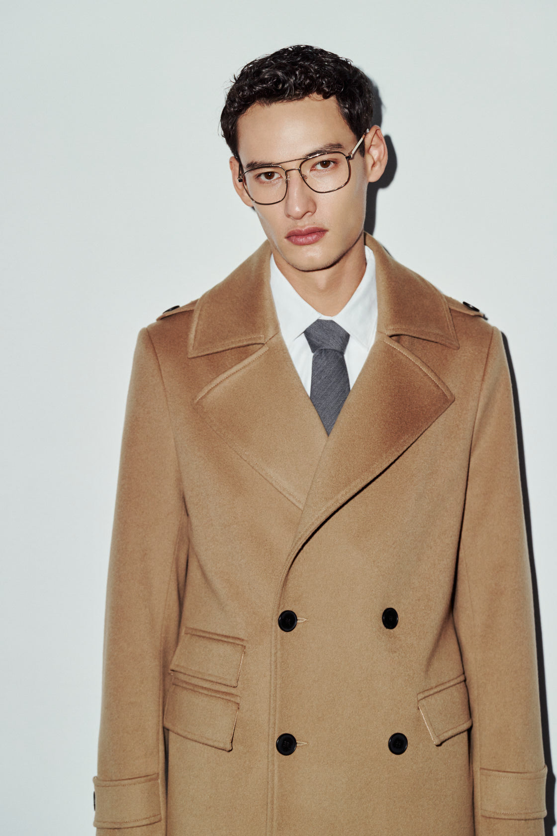 The JOSEPH Coat is a heritage-inspired longline double-breasted coat crafted in rich camel wool cashmere. Designed for a regular-fit fit with structured shoulders, wide peaked lapels, shoulder epaulets, and a straight fit, JOSEPH combines classic military tailoring with modern luxury. Functional flap side pockets with ticket pocket detailing, cuff tabs, and a double-breasted button closure make this coat as practical as it is versatile, perfect for elevated city styling or sharp cold-weather tailoring.
