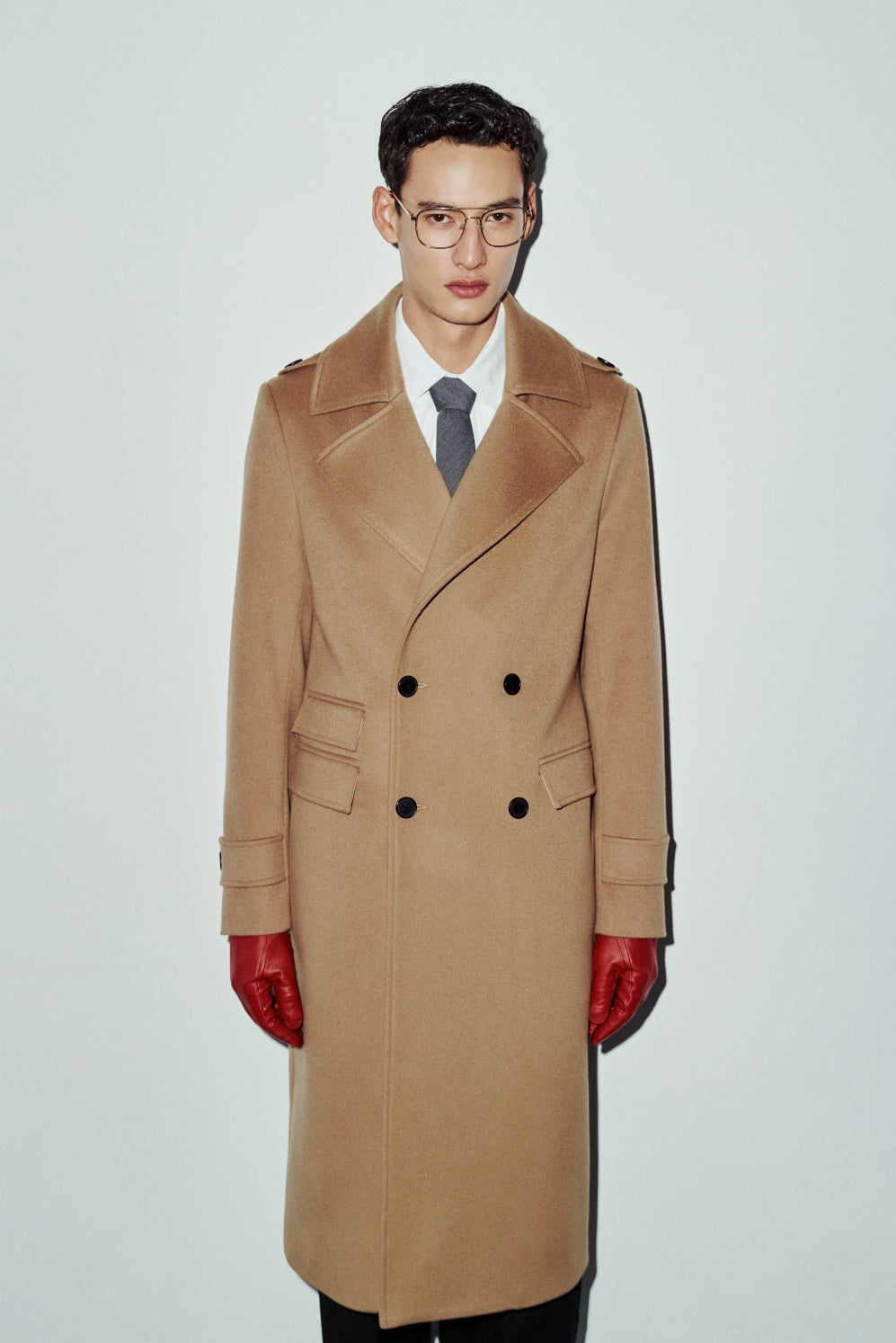 The JOSEPH Coat is a heritage-inspired longline double-breasted coat crafted in rich camel wool cashmere. Designed for a regular-fit fit with structured shoulders, wide peaked lapels, shoulder epaulets, and a straight fit, JOSEPH combines classic military tailoring with modern luxury. Functional flap side pockets with ticket pocket detailing, cuff tabs, and a double-breasted button closure make this coat as practical as it is versatile, perfect for elevated city styling or sharp cold-weather tailoring.
