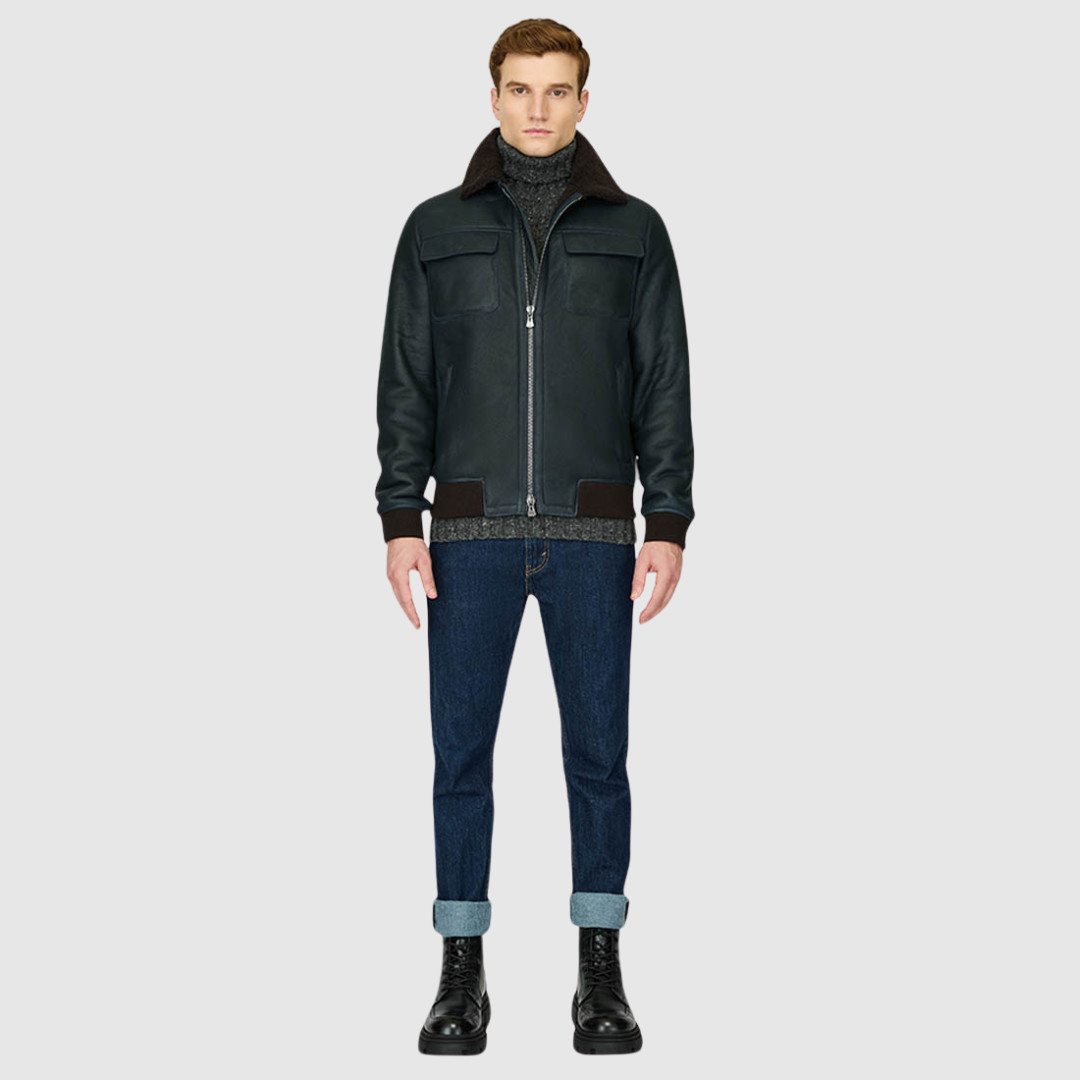 The Perez Navy Brown Shearling Bomber combines classic bomber styling with the luxury of supple nappa leather and a plush curly wool collar. Designed for a true-to-size fit, it features ribbed cuffs and a ribbed waistband for a secure, comfortable silhouette. Functional details such as zip side pockets and an interior zip pocket ensure everyday practicality, while the standard front zip closure keeps the design streamlined. Perez delivers timeless bomber attitude with a modern shearling upgrade.