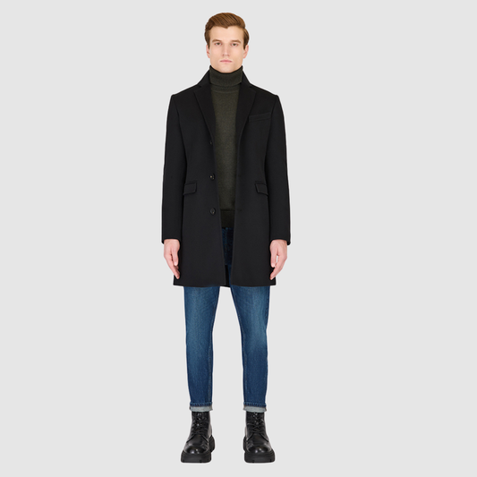 The Dylan Black Loro Piana Wool Coat captures refined sophistication through meticulous tailoring and Italian craftsmanship. Made from Loro Piana superfine wool, this single-breasted coat offers a slim fit through the arms and body, creating a sharp, modern silhouette ideal for both professional and evening wear. The notch collar, button-detailed cuffs, and flap side pockets add subtle sophistication, while the back vent ensures ease of movement and comfort. A single welt chest pocket completes this timeles