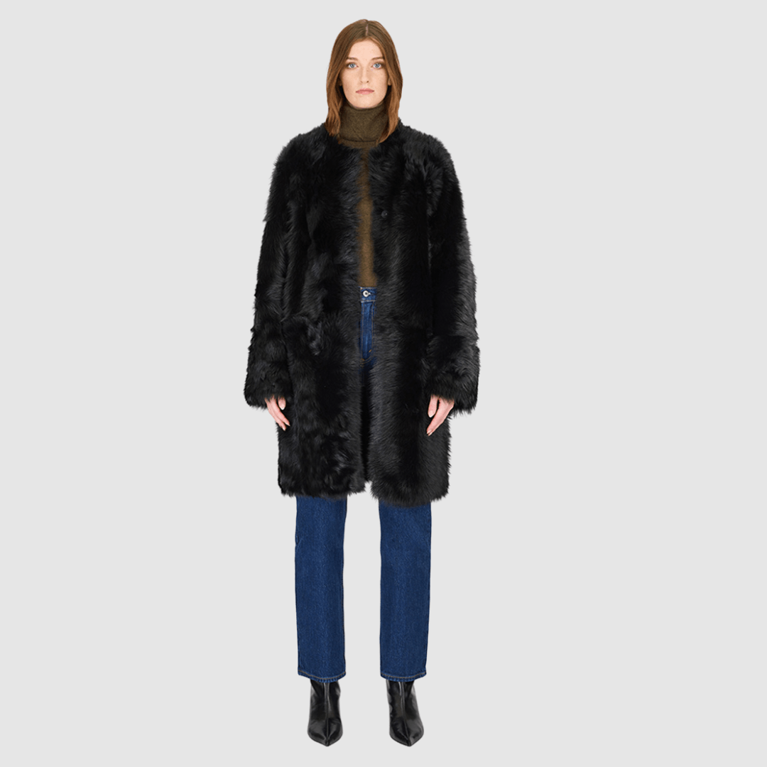 The ALLORA Jacket is a luxury reversible shearling teddy crafted in Jet Toscana for a rich and modern finish. Designed as a collarless regular fit silhouette, it effortlessly flips from plush wool-out shearling to a sleek nappa skin-out jacket, offering two looks in one. With its generous fit through the shoulders, arms, and torso, ALLORA balances comfort and style. Functional slash side pockets on both sides and a front snap closure complete this elevated women’s reversible shearling jacket.