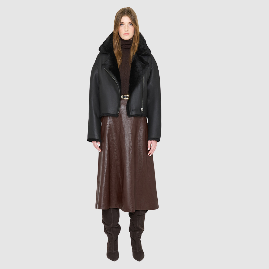 The ARIA Jacket is a luxury women’s shearling moto jacket designed with a reversible cropped silhouette that shifts effortlessly from sleek nappa leather to a plush curly wool teddy. With its drop shoulder and relaxed batwing sleeves, ARIA delivers an edgy yet easy fit that flatters every look. An oversized notch collar brings statement structure, while practical pockets on both sides and an asymmetrical front zip with single button closure ensure both style and function. 