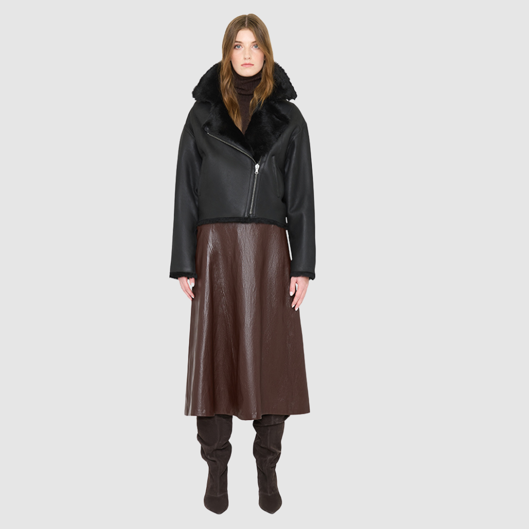 The ARIA Jacket is a luxury women’s shearling moto jacket designed with a reversible cropped silhouette that shifts effortlessly from sleek nappa leather to a plush curly wool teddy. With its drop shoulder and relaxed batwing sleeves, ARIA delivers an edgy yet easy fit that flatters every look. An oversized notch collar brings statement structure, while practical pockets on both sides and an asymmetrical front zip with single button closure ensure both style and function.