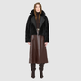 The ARIA Jacket is a luxury women’s shearling moto jacket designed with a reversible cropped silhouette that shifts effortlessly from sleek nappa leather to a plush curly wool teddy. With its drop shoulder and relaxed batwing sleeves, ARIA delivers an edgy yet easy fit that flatters every look. An oversized notch collar brings statement structure, while practical pockets on both sides and an asymmetrical front zip with single button closure ensure both style and function.