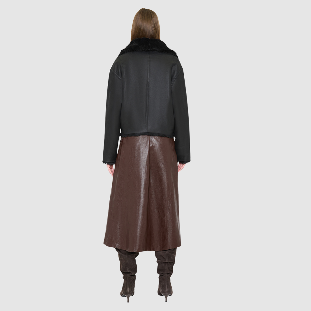 The ARIA Jacket is a luxury women’s shearling moto jacket designed with a reversible cropped silhouette that shifts effortlessly from sleek nappa leather to a plush curly wool teddy. With its drop shoulder and relaxed batwing sleeves, ARIA delivers an edgy yet easy fit that flatters every look. An oversized notch collar brings statement structure, while practical pockets on both sides and an asymmetrical front zip with single button closure ensure both style and function.