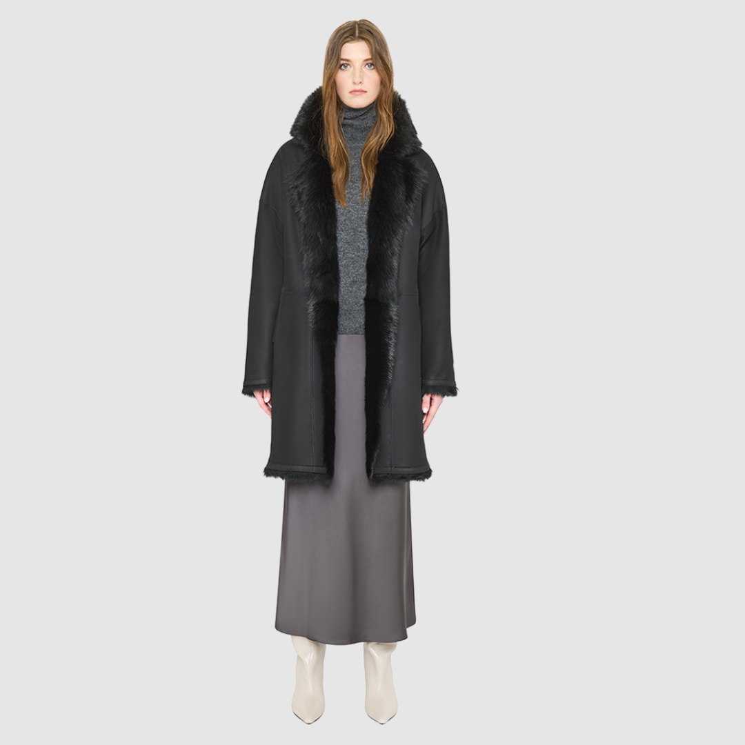 AUGUST is a heritage-inspired reversible medium-length coat crafted with a suede and toscana shearling combination. Designed for a relaxed silhouette with drop shoulders, an exaggerated notched collar with plush trim, and a straight fit, AUGUST combines modern edge with timeless texture. Functional slash pockets on the wool side, clean welt pockets on the nappa side, and a front button closure make this coat as practical as it is versatile, perfect for après-ski layering or elevated city styling.