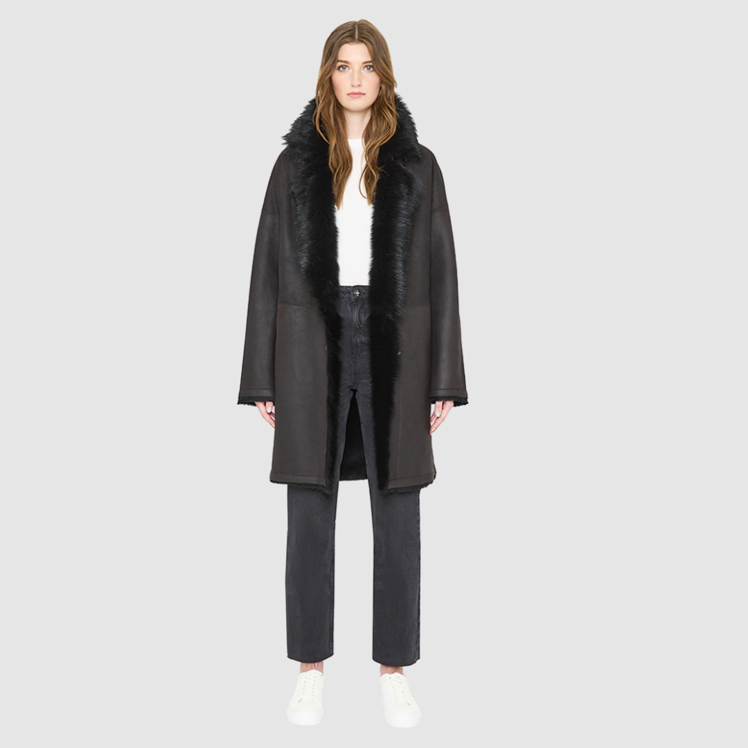 AUGUST is a heritage-inspired reversible medium-length coat crafted with a semi suede and toscana shearling combination. Designed for a relaxed silhouette with drop shoulders, an exaggerated notched collar with plush trim, and a straight fit, AUGUST combines modern edge with timeless texture. Functional slash pockets on the wool side, clean welt pockets on the semi suede side, and a front button closure make this coat as practical as it is versatile, perfect for après-ski layering or elevated city styling.