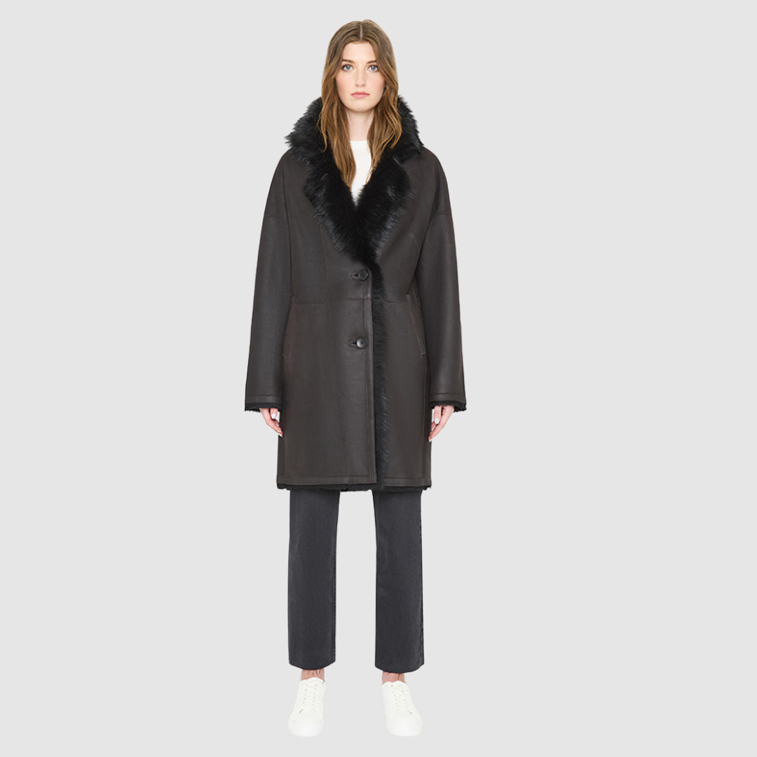 AUGUST is a heritage-inspired reversible medium-length coat crafted with a semi suede and toscana shearling combination. Designed for a relaxed silhouette with drop shoulders, an exaggerated notched collar with plush trim, and a straight fit, AUGUST combines modern edge with timeless texture. Functional slash pockets on the wool side, clean welt pockets on the semi suede side, and a front button closure make this coat as practical as it is versatile, perfect for après-ski layering or elevated city styling.
