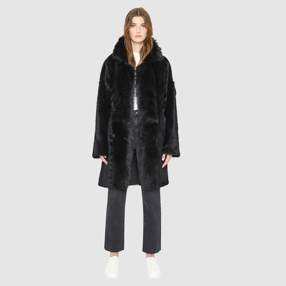 AUGUST is a heritage-inspired reversible medium-length coat crafted with a semi suede and toscana shearling combination. Designed for a relaxed silhouette with drop shoulders, an exaggerated notched collar with plush trim, and a straight fit, AUGUST combines modern edge with timeless texture. Functional slash pockets on the wool side, clean welt pockets on the semi suede side, and a front button closure make this coat as practical as it is versatile, perfect for après-ski layering or elevated city styling.