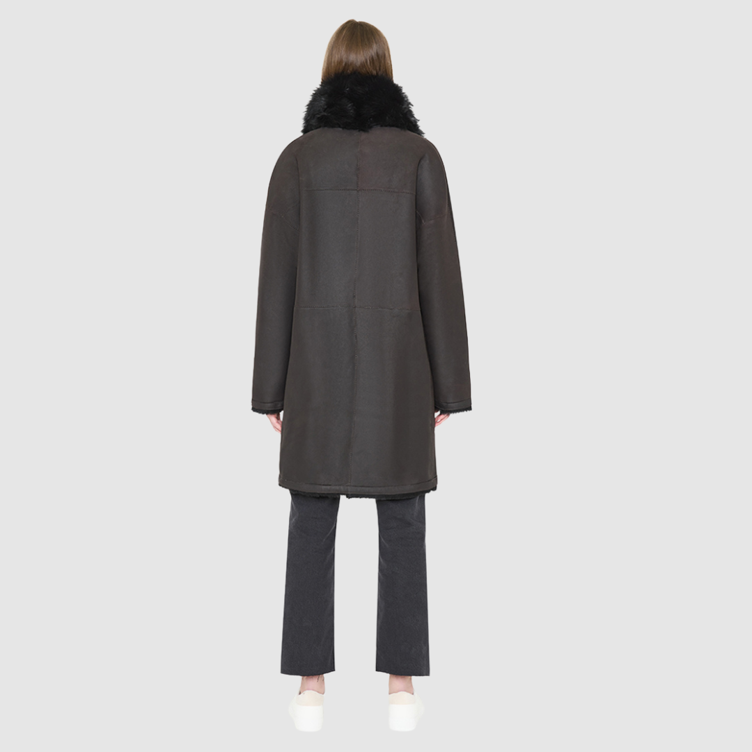 AUGUST is a heritage-inspired reversible medium-length coat crafted with a semi suede and toscana shearling combination. Designed for a relaxed silhouette with drop shoulders, an exaggerated notched collar with plush trim, and a straight fit, AUGUST combines modern edge with timeless texture. Functional slash pockets on the wool side, clean welt pockets on the semi suede side, and a front button closure make this coat as practical as it is versatile, perfect for après-ski layering or elevated city styling.