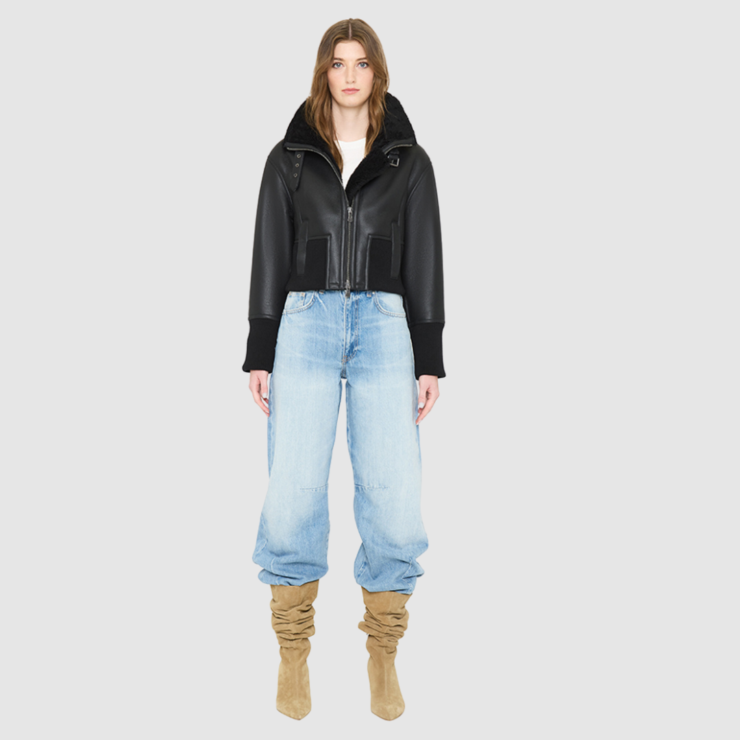The CAVALLO delivers sharp alpine chic tailored for a metropolitan winter. This bomber jacket pairs rich brown matte nappa leather with a plush cream curly wool interior. Featuring integrated ribbed knit trim and a bold buckled collar, the cropped silhouette balances high-fashion utility with quiet luxury. Ideal for effortless layering, it moves easily from casual streetwear to an upscale cold-weather destination.
