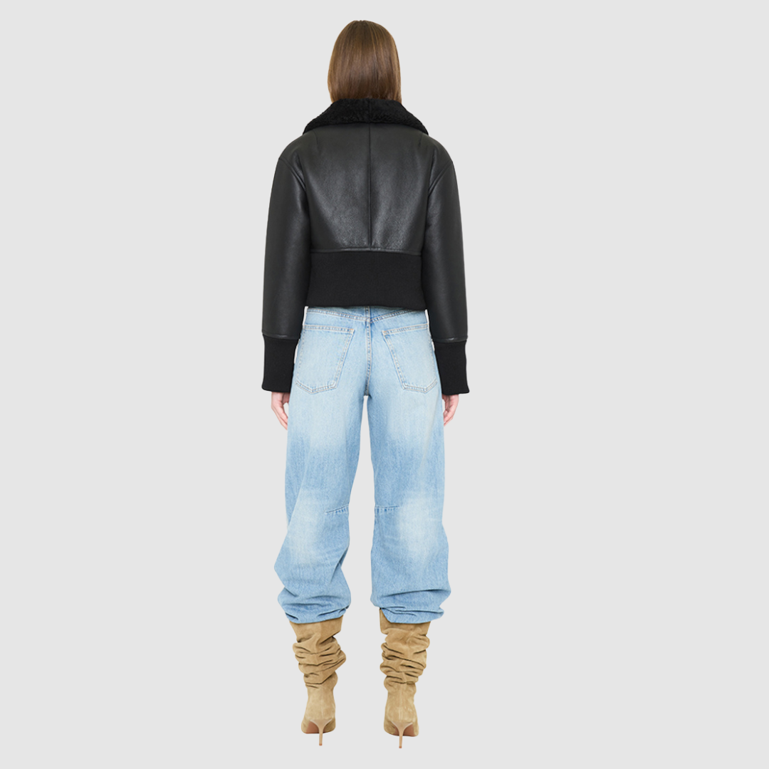 The CAVALLO delivers sharp alpine chic tailored for a metropolitan winter. This bomber jacket pairs rich brown matte nappa leather with a plush cream curly wool interior. Featuring integrated ribbed knit trim and a bold buckled collar, the cropped silhouette balances high-fashion utility with quiet luxury. Ideal for effortless layering, it moves easily from casual streetwear to an upscale cold-weather destination.