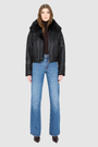 The CLARITY shearling bomber jacket offers a modern take on the classic bomber jacket, combining rugged function with luxurious texture. Crafted in a rich jet black nappa leather and plush, dark rasado shearling wool interior, it delivers an elevated cold-weather look. Designed with a drop shoulder and a high shearling collar, it balances structure with relaxed ease. A tonal ribbed knit waistband, structural paneling, and clean hardware details lend utility to this elegant semi-fitted style