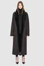 The DANIELLE Duster is a statement in heritage-inspired luxury and modern versatility. Crafted in java semi suede leather and plush curly wool shearling, this reversible oversized coat transitions effortlessly from sleek leather to cozy teddy texture. Its elongated silhouette is enhanced with a slight drop shoulder, back vent, and double-breasted button closure, creating timeless elegance with functional edge. Practical single welt pockets on the semi suede side and slash pockets on the wool side