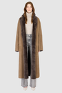 The DANIELLE Duster is a statement in heritage-inspired luxury and modern versatility. Crafted in kangaroo suede leather and plush curly wool shearling, this reversible oversized coat transitions effortlessly from sleek leather to cozy teddy texture. Its elongated silhouette is enhanced with a slight drop shoulder, back vent, and double-breasted button closure, creating timeless elegance with functional edge. Practical single welt pockets on the suede side and slash pockets on the wool side.
