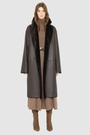 The ELLE Coat is a heritage-inspired oversized reversible shearling piece crafted in a chocolate nappa ironed wool teddy. Designed to transition seamlessly from smooth suede to plush wool-out texture, this versatile style blends timeless tailoring with modern après-ski elegance. A slight drop shoulder, double-breasted button closure, and back vent add structure to its oversized silhouette. Functional single welt pockets on the suede side and slash pockets on the ironed wool side 