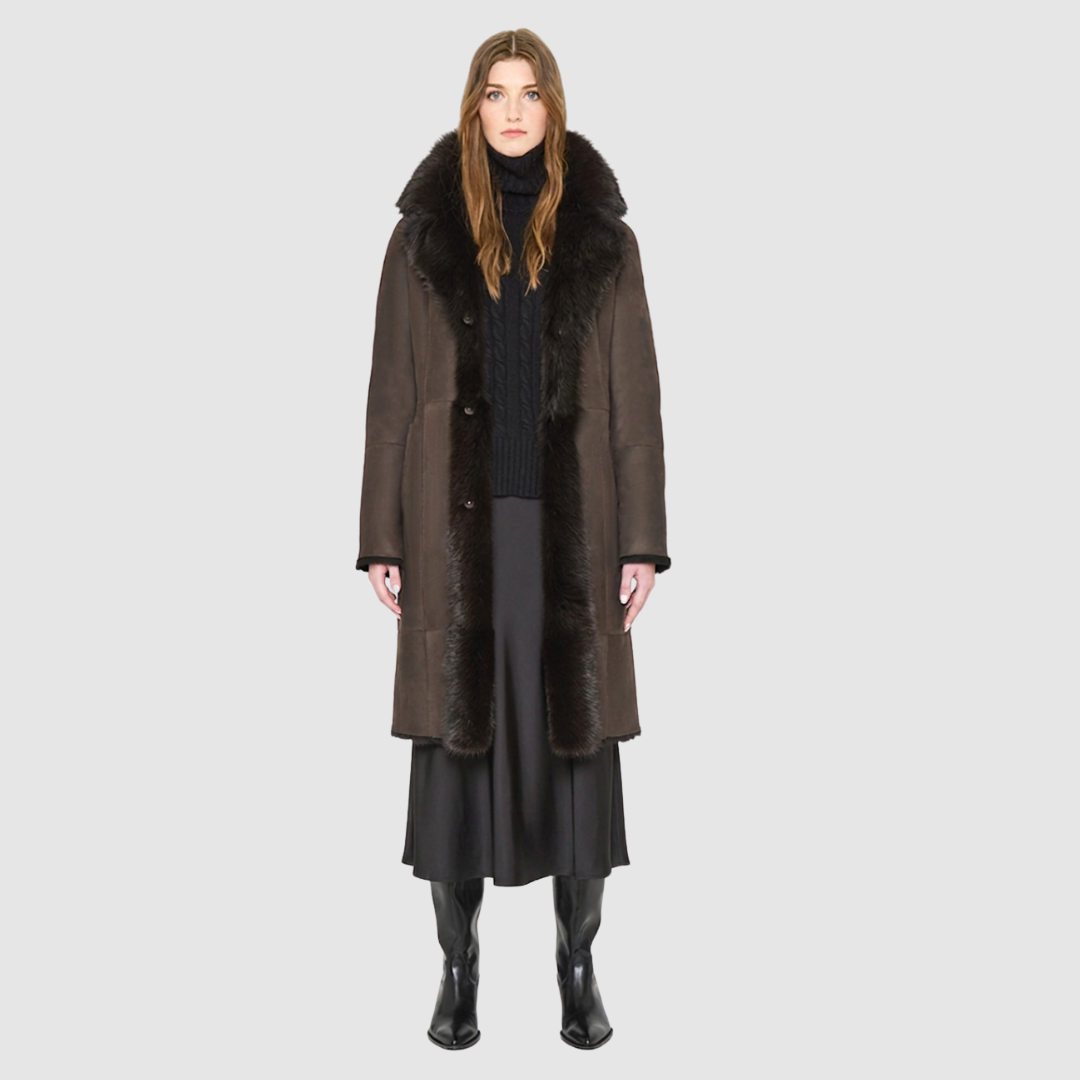 The GRAIL Reversible Shearling Coat offers a modern take on the classic long coat, combining rugged function with luxurious texture. Crafted in a rich suede that reverses to a plush, long-haired wool Toscana shearling, it delivers two distinct looks in one. Designed with a regular shoulder and an oversized notch collar, it balances structure with relaxed ease. Clean tailored panels and versatile integrated pocketing lend utility to this elegant semi-fitted style