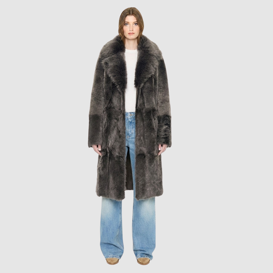 The GRAIL Reversible Shearling Coat offers a modern take on the classic long coat, combining rugged function with luxurious texture. Crafted in a rich nappa that reverses to a plush, long-haired wool Toscana shearling, it delivers two distinct looks in one. Designed with a regular shoulder and an oversized notch collar, it balances structure with relaxed ease. Clean tailored panels and versatile integrated pocketing lend utility to this elegant semi-fitted style