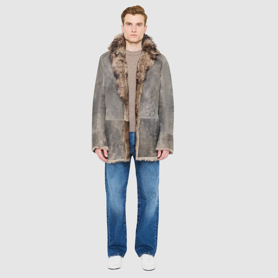 The Josh Opposum Reversible Shearling Jacket embodies modern versatility with heritage-inspired tailoring. Crafted in supple suede and fully reversible to a textured ironed wool teddy, it offers two distinct looks in one. Structured and streamlined when worn wool-in, or relaxed and easy when worn wool-out, this piece adapts effortlessly to changing moods and occasions. Finished with a notch collar, raw edge detailing, and functional slash pockets on both sides, Josh delivers understated luxury