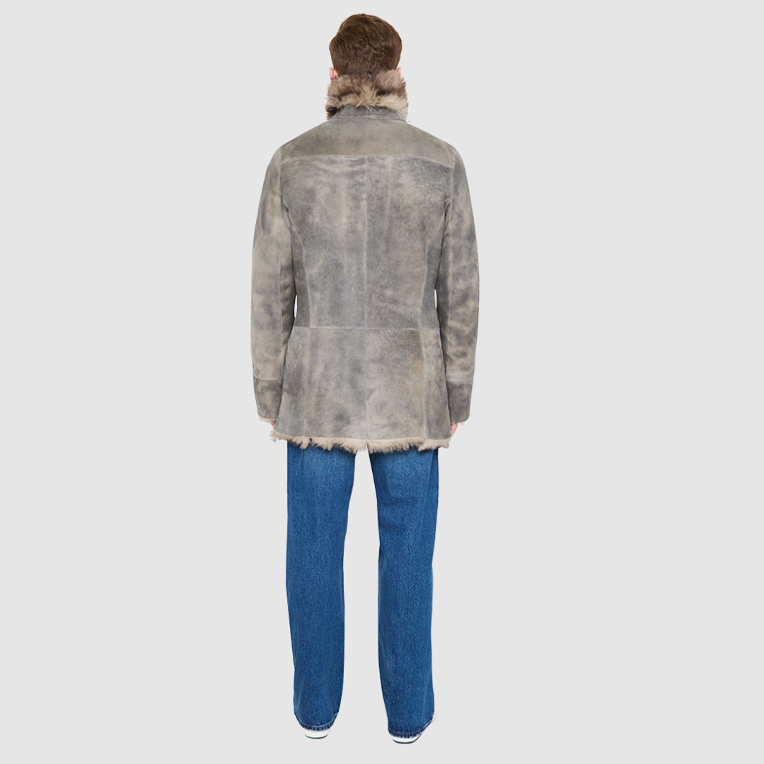 The Josh Opposum  Reversible Shearling Jacket embodies modern versatility with heritage-inspired tailoring. Crafted in supple suede and fully reversible to a textured ironed wool teddy, it offers two distinct looks in one. Structured and streamlined when worn wool-in, or relaxed and easy when worn wool-out, this piece adapts effortlessly to changing moods and occasions. Finished with a notch collar, raw edge detailing, and functional slash pockets on both sides, Josh delivers understated luxury