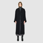 The LEONA Coat is a modern full-length silhouette crafted in a premium black wool blend. Designed with drop shoulders, wide kimono-inspired sleeves, and an easy, relaxed drape, it delivers effortless volume and architectural lines. A clean collarless V-neckline and single-breasted button closure give it a sleek, minimalist finish, while a matching tie belt and elasticized back waist offer versatile styling. Fully lined for comfort, LEONA serves as a definitive statement coat for elevated cold-weather 