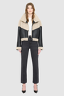 The LILITH Jacket is a heritage-inspired cropped shearling jacket crafted from black nappa leather with plush, contrasting beige wool detailing for modern texture and dimension. Its drop shoulder and relaxed cropped silhouette create a sleek, contemporary fit, while a dramatic chevron-blocked design across the chest, shoulders, and sleeves adds a striking graphic edge. Featuring a multi-functional front zip closure that deep side pockets, and exposed beige shearling trim at the cuffs and hem, LILITH is as p