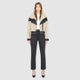 The LILITH Jacket is a heritage-inspired cropped shearling jacket crafted from black nappa leather with plush, contrasting beige wool detailing for modern texture and dimension. Its drop shoulder and relaxed cropped silhouette create a sleek, contemporary fit, while a dramatic chevron-blocked design across the chest, shoulders, and sleeves adds a striking graphic edge. Featuring a multi-functional front zip closure that deep side pockets, and exposed beige shearling trim at the cuffs and hem, LILITH is as p