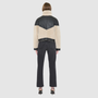The LILITH Jacket is a heritage-inspired cropped shearling jacket crafted from black nappa leather with plush, contrasting beige wool detailing for modern texture and dimension. Its drop shoulder and relaxed cropped silhouette create a sleek, contemporary fit, while a dramatic chevron-blocked design across the chest, shoulders, and sleeves adds a striking graphic edge. Featuring a multi-functional front zip closure that deep side pockets, and exposed beige shearling trim at the cuffs and hem, LILITH is as p
