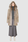 The LOVER reversible shearling jacket offers a modern take on the classic hooded long coat, combining rugged function with luxurious texture. Crafted in a rich smoked quartz suede that reverses to a plush, toscana rasado wool interior, it delivers two distinct looks in one. Designed with a regular shoulder and an oversized shearling hood, it balances structure with relaxed ease. Clean tailored panels and versatile integrated pocketing lend utility to this elegant semi-fitted style